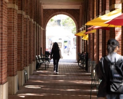 Student walking outside Fertitta Hall