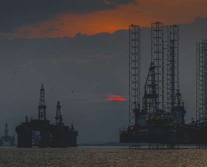 Ocean oil rigs at sunset.