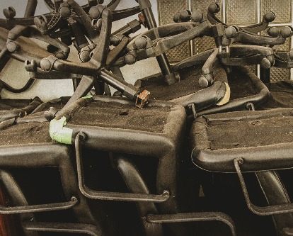 Stacked broken and abandoned office chairs.