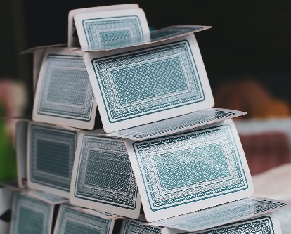 Color photography of a house of cards.