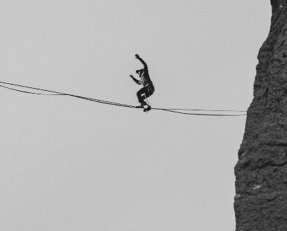 Black and white photograph of a tightrope walker.