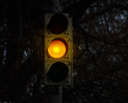 Stoplight with yellow bulb active.