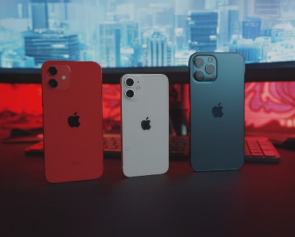 Three iPhones standing next to one another.