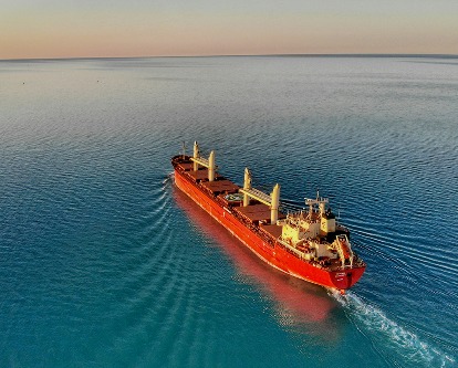 A cargo ship sailing across the sea.