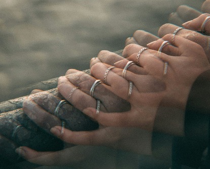 Photo manipulation of two people holding hands.