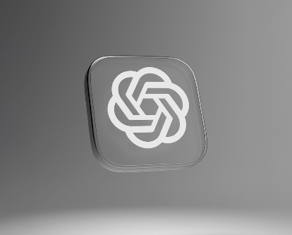 The ChatGPT glyph floating on a grey stage.