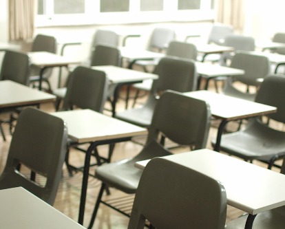 Color photograph of an empty school classroom.