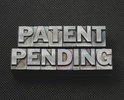 Printing letters spelling out &quot;Patent Pending&quot;.