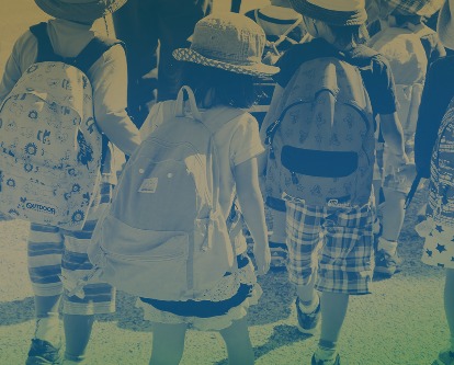 Four elementary school children walking.