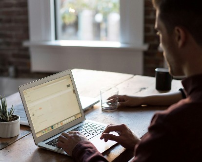 Two people working on a laptop.
