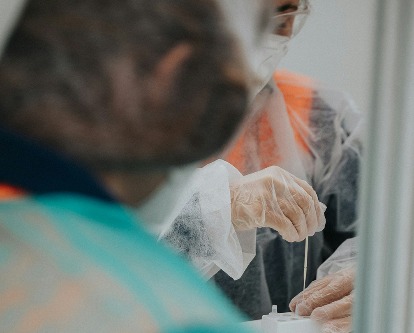 A person administering a COVID test.