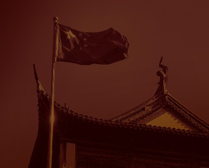 The Chinese flag flying near a temple.