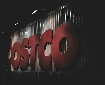 A Costco sign at night.