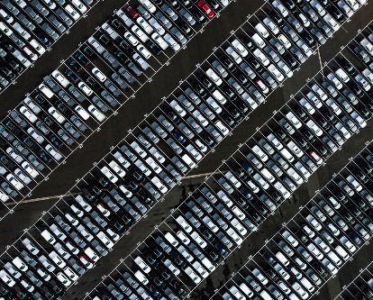 Overhead shot of a car lot.