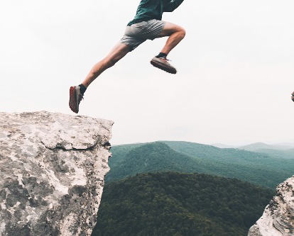 Man jumping from a rock.