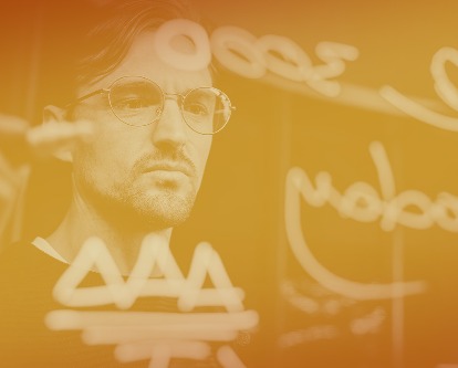 Man working on a glassboard.
