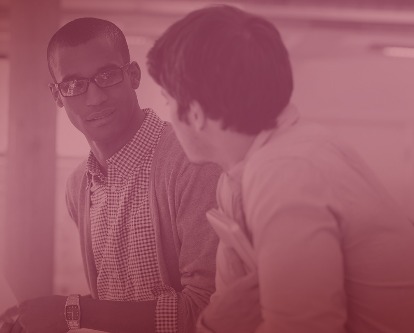 Two coworkers holding a conversation.