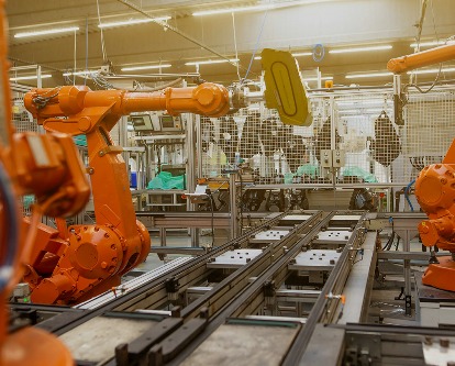 Robots in a factory assembling products.