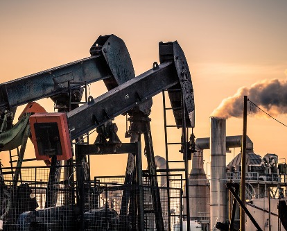 Two oil pumps at sunset.