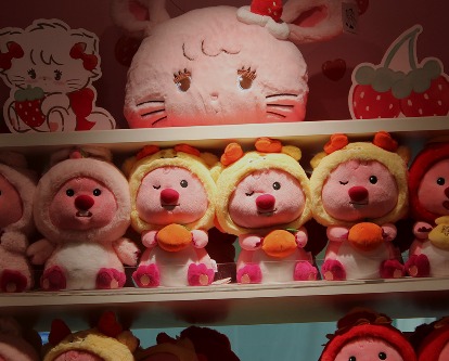 Shelves of plush toys in a store.