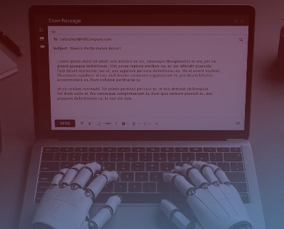 Robot hands typing an email on a laptop.