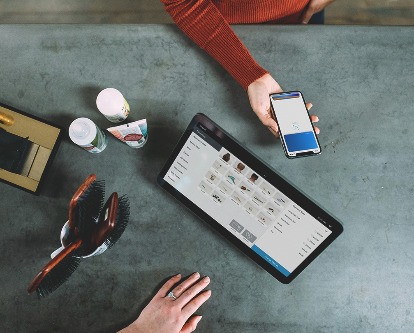 Overhead photo of a person making a purchase with their smartphone.