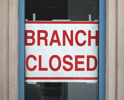 A sign in a window reading Branch Closed.