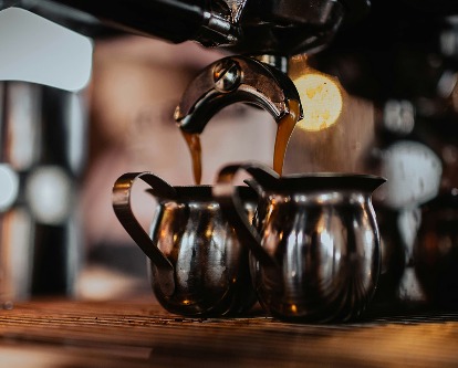 Espresso shots being poured from a machine.