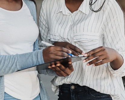 Women signing a petition.