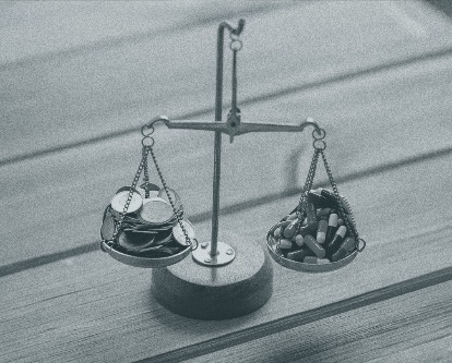 A duotone image of a scale. On one side is a stack of coins while on the other a pile of pills.