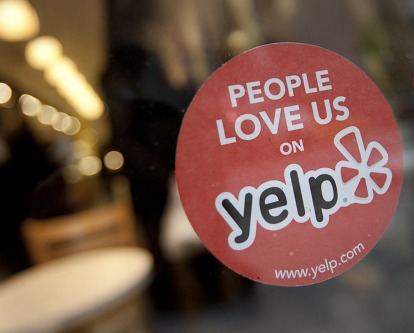 A store window with a &quot;People Love Us on Yelp&quot; sticker.