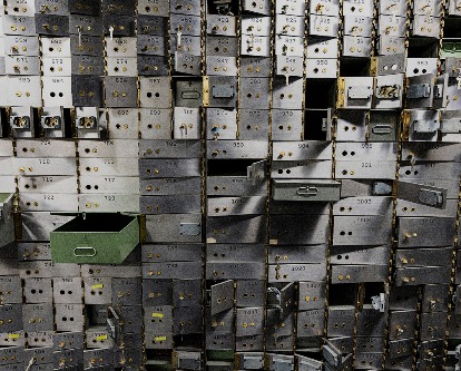 A wall of empty safety deposit boxes.