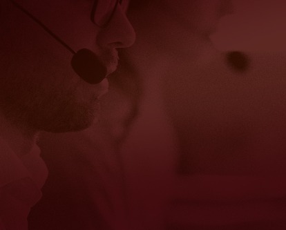 Two telemarketers on phone calls.