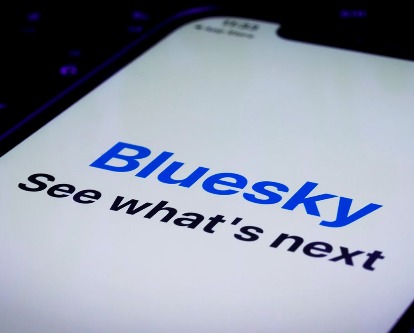 Bluesky social loading screen on a smartphone.