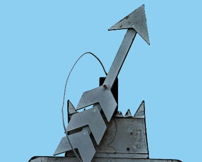 Metal arrow sign pointing up.