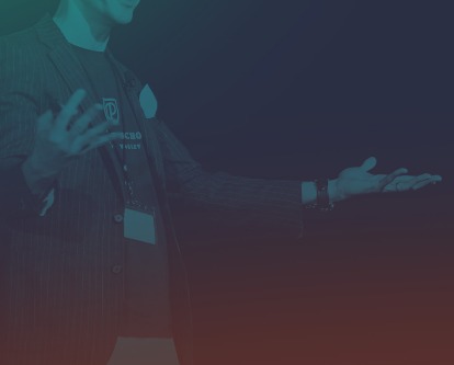 A male-presenting speaker emphasizing a point with their hands.