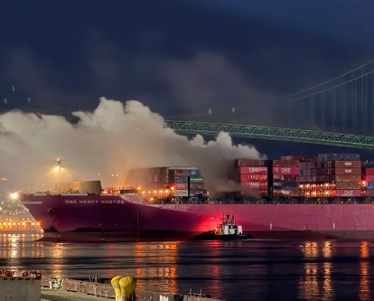 A cargo ship with a fire onboard in the port of Long Beach.