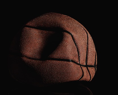 Deflated and rumpled old basketball ball.