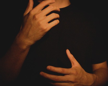 Male-presenting hands in motion while talking.