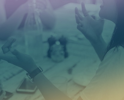 A female-presenting person using her hands to emphasize a point in conversation.