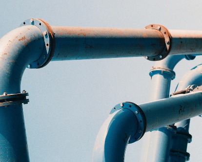 Color photograph of gas lines set against blue skies.
