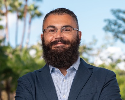 Color photograph of assistant professor of management and organization Joe Raffiee on the USC campus.