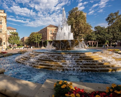Outdoor plaza with flowing water fountain and blue sky