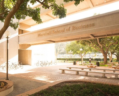 Color outdoor photograph depicting Marshall School of Business signage at Bridge Hall