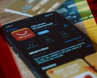Color photograph of a mobile phone displaying the AliExpress app in iOS.