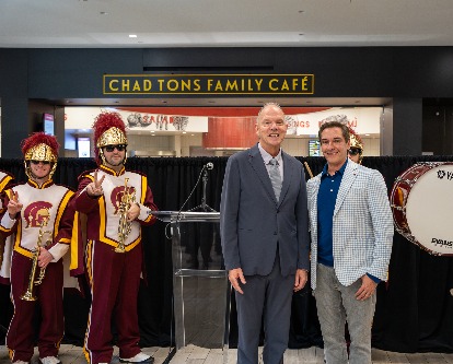 Chad Tons and Dean Geoff Garrett in front of the Chad Tons Family Cafe.
