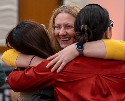Rahsan Akbulut hugging two colleagues