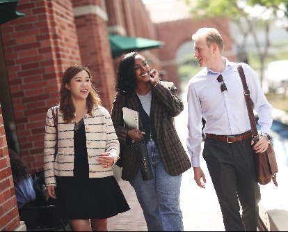 three Marshall students walking through campus