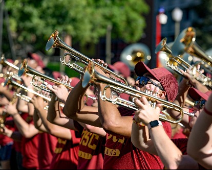 The USC band's trumpet section plays in t-shirts