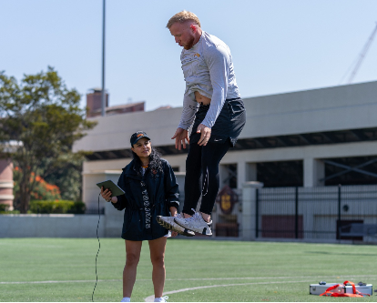 Lorena Martin watching a student jump during a class